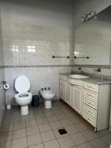a bathroom with a toilet and a sink at Dpto Pedro Vargas in Mendoza