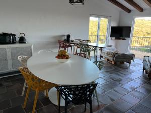 a dining room with a white table and chairs at Nature&Soul - MAR in Vila do Bispo