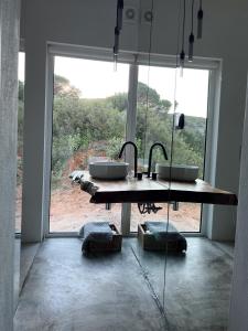 a bathroom with two sinks and a large window at Nature&Soul - MAR in Vila do Bispo