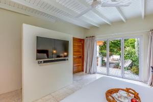 a living room with a large tv on the wall at Naïma Luxury Home, Cottage & Apartment Rentals in Paradera