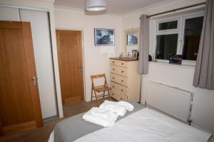 a bedroom with a bed with white towels on it at No. 2 Watch House in Dawlish