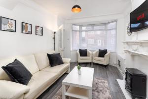 a living room with a couch and a fireplace at The Empress 2 Bed Terraced House in Liverpool