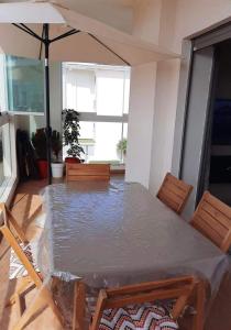 a dining room with a table covered in plastic at Karate in Kent