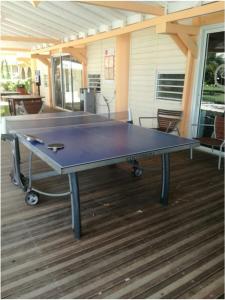 a ping pong table on top of a deck at Studio dans Résidence Hotelière aux 3ilets Pointe du bout Résidence la Marina Carayou in Les Trois-Îlets