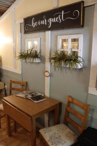 a dining room with a table and a sign on the wall at Acorn Hideaways Canton Sweet Dreams for 2 in Canton