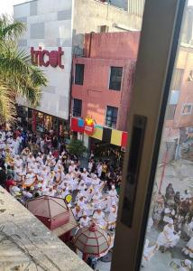 a crowd of people in white uniforms standing in a street at Estudio21centro in Arica