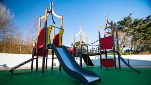 a playground with a slide in a park at Our Lodge at Newquay Bay NB35 in Newquay