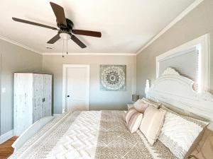 a bedroom with a bed with a ceiling fan at Cozy and Renovated 3 Bedroom Home 