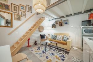 a living room with a staircase and a couch at Mezzanine Stylish Apartments by Vacationy in Porto