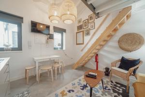 a living room with a staircase and a table and chairs at Mezzanine Stylish Apartments by Vacationy in Porto