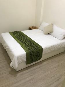 Postel nebo postele na pokoji v ubytování Four Seasons Homestay