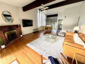 a living room with a couch and a fireplace at Newly Remodeled Mid-Century Modern Lake Condo in Lake Geneva
