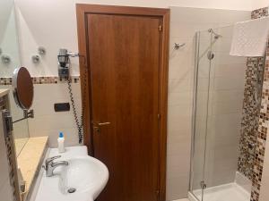 a bathroom with a shower and a toilet and a sink at Le Stanze Del Vicerè Boutique Hotel in Naples