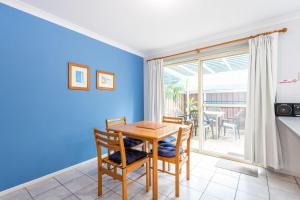 a kitchen and dining room with a table and chairs at Clifton on Charles in Iluka