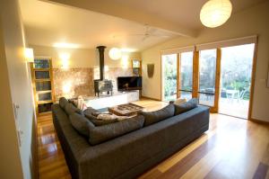 a living room with a couch and a fireplace at SUNNY DAZE in Point Lonsdale