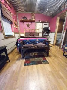 ein Schlafzimmer mit einem Bett in einem Zimmer in der Unterkunft Acorn Hideaways Canton Cozy Frontier Suite 1890s Cattle & Land Decor in Canton