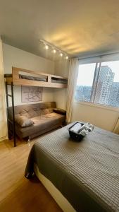 a bedroom with a bed and a large window at MV 148A Espetacular Apartamento Em Frente Ao Metrô Brás ! - Rua Coronel Mursa, 56 - Bras in Sao Paulo