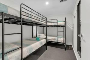 a room with two bunk beds in a room at River Life in Wellington East