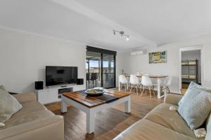 a living room with a couch and a table at River Life in Wellington East