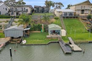 an aerial view of a house on the water at River Life in Wellington East