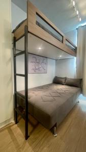 a bedroom with a bunk bed with a ladder at MV 148A Espetacular Apartamento Em Frente Ao Metrô Brás ! - Rua Coronel Mursa, 56 - Bras in Sao Paulo