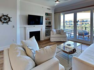 a living room with a white couch and a fireplace at Adagio #303E in Santa Rosa Beach