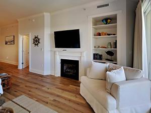 a living room with a white couch and a fireplace at Adagio #303E in Santa Rosa Beach +62 photos