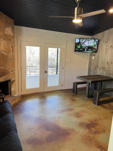 a living room with a ping pong table and a fireplace at Hideout on the Horseshoe in Canyon Lake