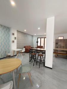 a room with tables and chairs and a couch at Kawa Living in Krukah