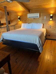 a bedroom with a bed in a wooden cabin at Hideout on the Horseshoe in Canyon Lake