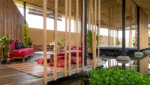 a living room with a couch and a table at Let's Get Lost Ubud in Ubud