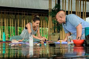 a man and a woman playing a game on a table at Let's Get Lost Ubud in Ubud
