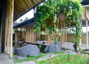 a building with a bunch of ivy hanging from it at Let's Get Lost Ubud in Ubud
