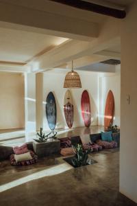 a room with surfboards lined up against a wall at Vedya Boutique Hostel in General Luna