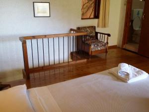 a bedroom with a bed and a chair in a room at Beautiful Cottage in S West Crete near the sea in Palaiochóra
