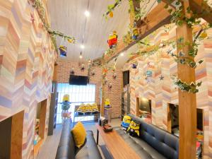 une chambre pour enfants avec un canapé bleu et un mur coloré dans l'établissement Hotel Jungle fun fun, à Osaka