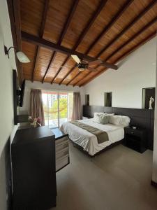 a bedroom with a large bed and a wooden ceiling at Serenity Suites Casa Boutique in Bucaramanga