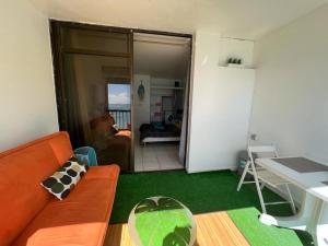 a living room with a couch and a table at OCEANE 2 in Le Gosier