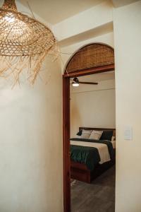 a bedroom with a bed with a canopy bed at Vedya Boutique Hostel in General Luna