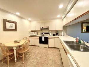 a small kitchen with a table and a sink at Tropical Paradise Key West in Key West