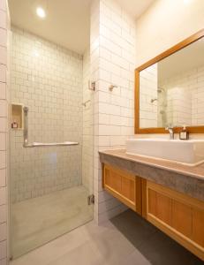 a bathroom with a sink and a mirror at Navela Hotel & Convention in Ratchaburi