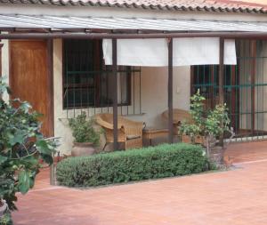 a patio with two chairs and a table and windows at Casa Campestre del Mangrullo in Mexico City +16 photos