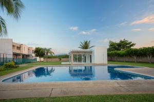 a swimming pool in front of a house at Casa Amor in Puerto Vallarta