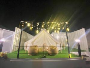 a white tent on a stage with lights at ดูดาวแคมป์ริมโขง in Chiang Khan