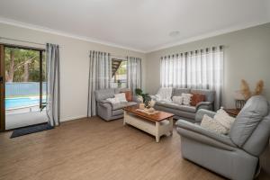 a living room with two couches and a table at Drifters @ Callala Beach in Callala Beach