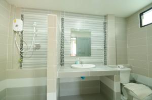 a white bathroom with a sink and a shower at Haadson Resort & Koh Raham in Haad Son