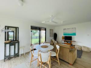 a living room with a table and chairs and a couch at 18 Knudsen Street in Elliott Heads