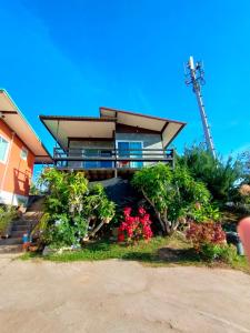 a house with a bunch of flowers in front of it at Khao Kho Tree Top in Khao Kho