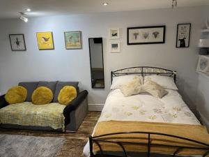 a bedroom with a bed and a couch at The studio (Hideaway) Dog friendly in Matlock