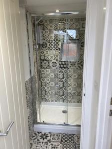 a bathroom with a shower with a glass door at The studio (Hideaway) Dog friendly in Matlock